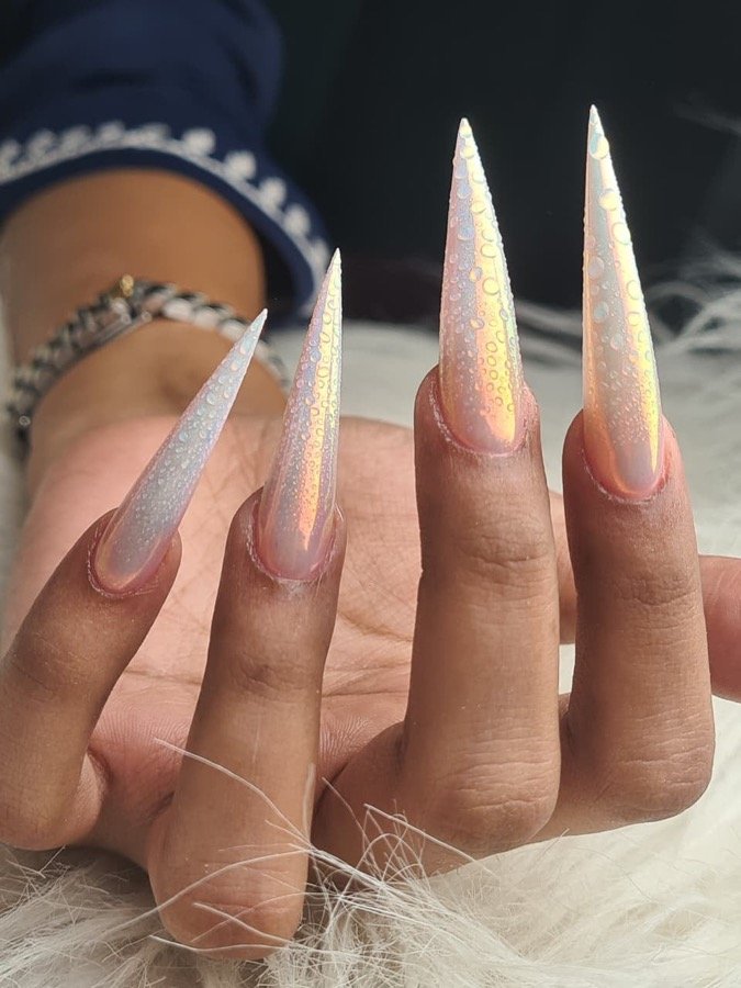 Long glitter stiletto nails with white floral accents