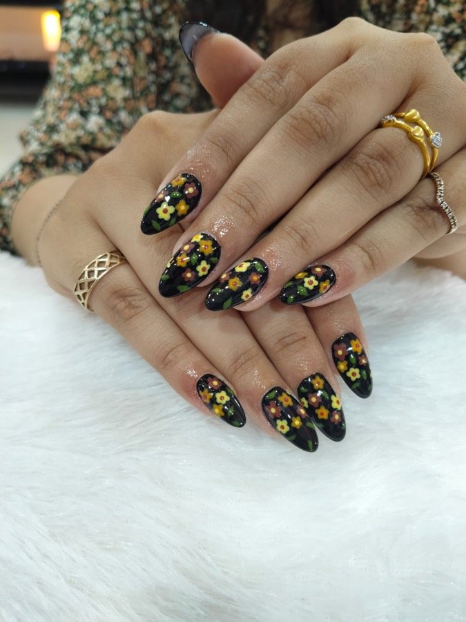 Black nails with gold and floral hand-painted art