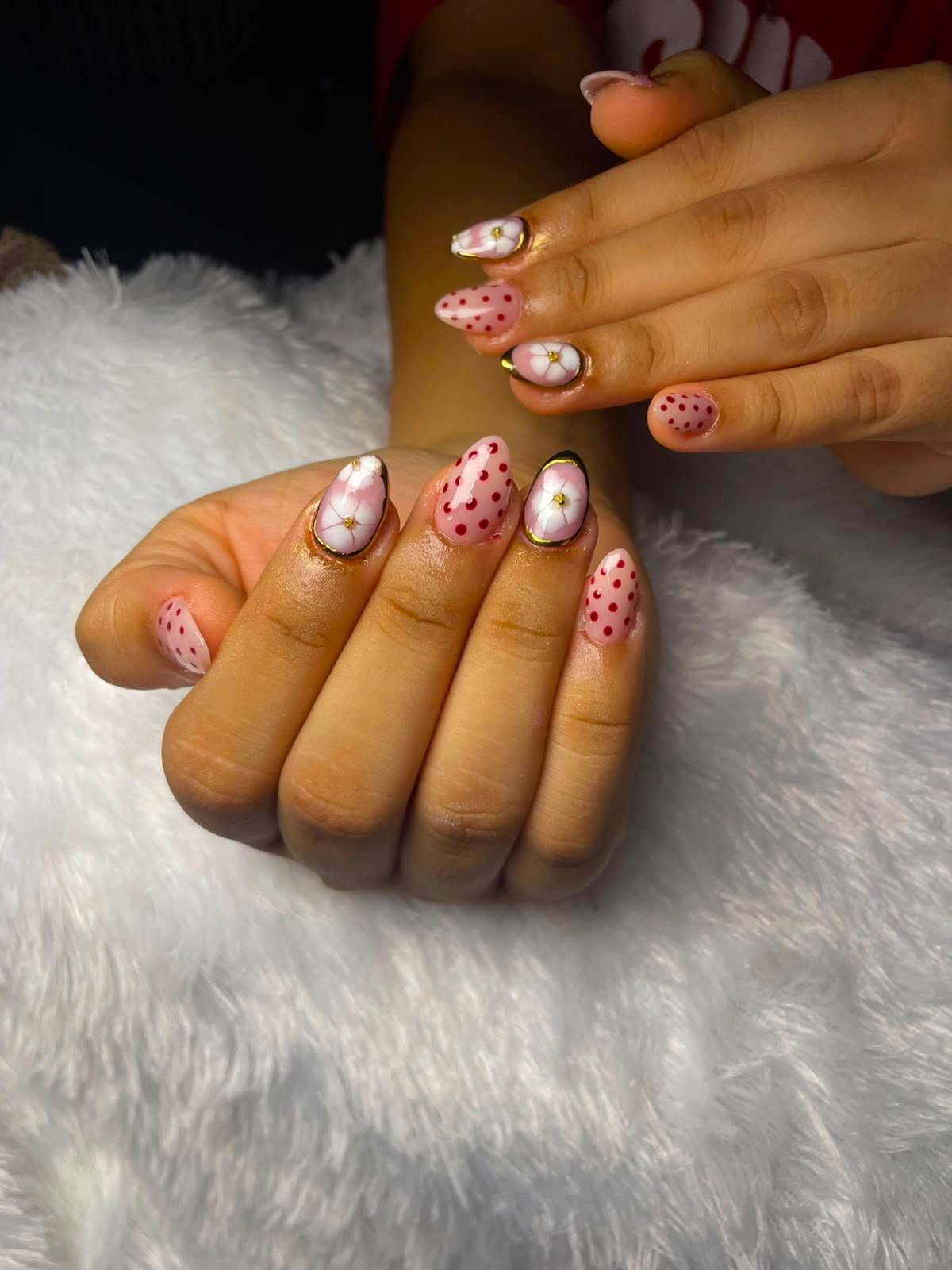 Elegant almond nails with pink floral and polka-dot gel art